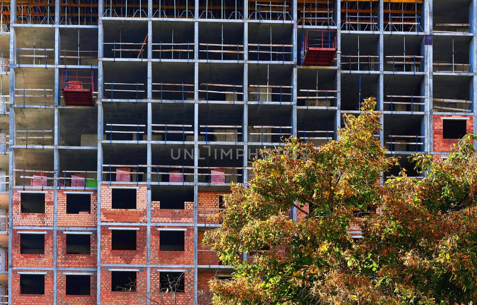 Construction of a brick multi storey building. Packing bricks on floors by jovani68