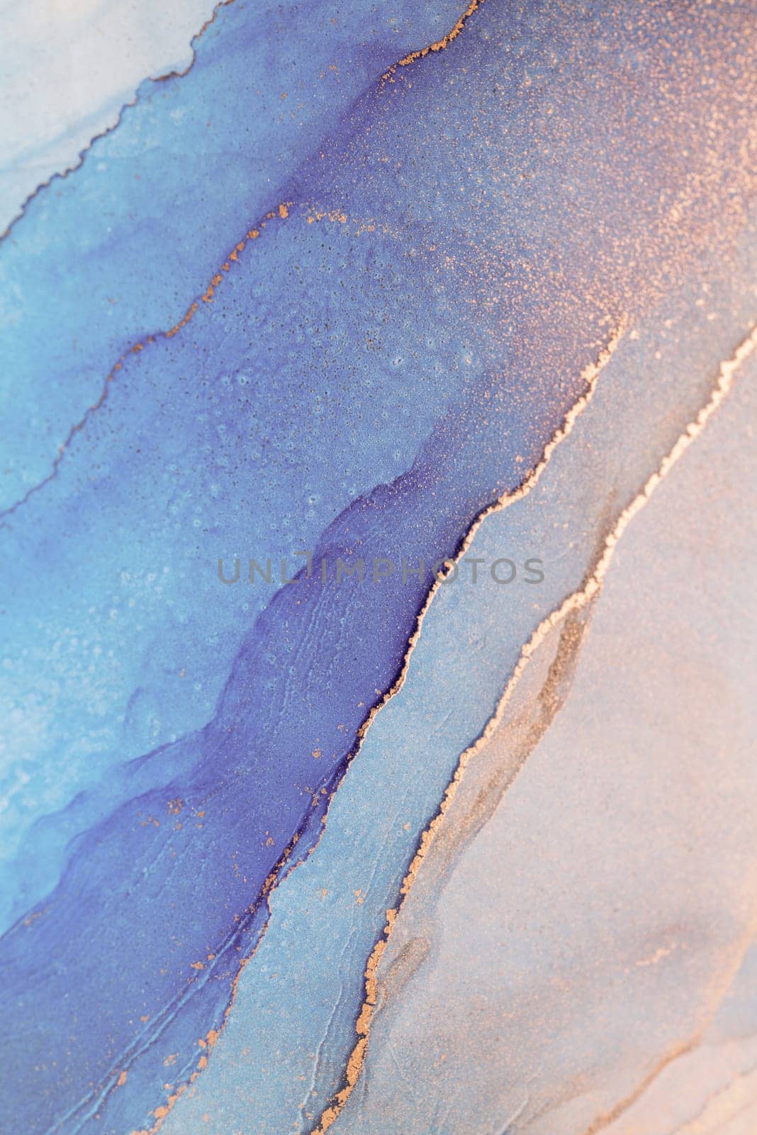 A close-up shot of an abstract painting with swirling shades of blue and gold, creating a mesmerizing and artistic visual.