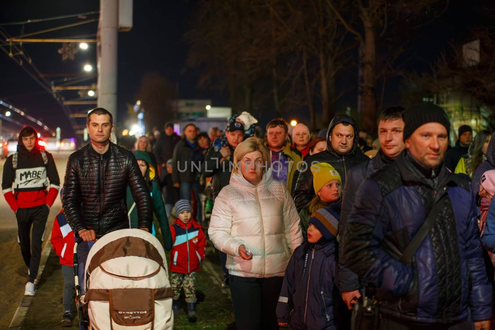 crowd of Russian people walking along the city street sidewalk at night after celebration of victory day by z1b