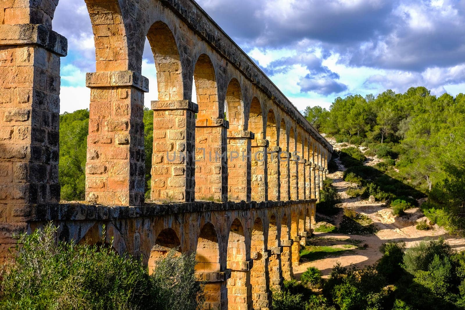 Roman aqueduct. Old stone bridge. Spain . High quality photo