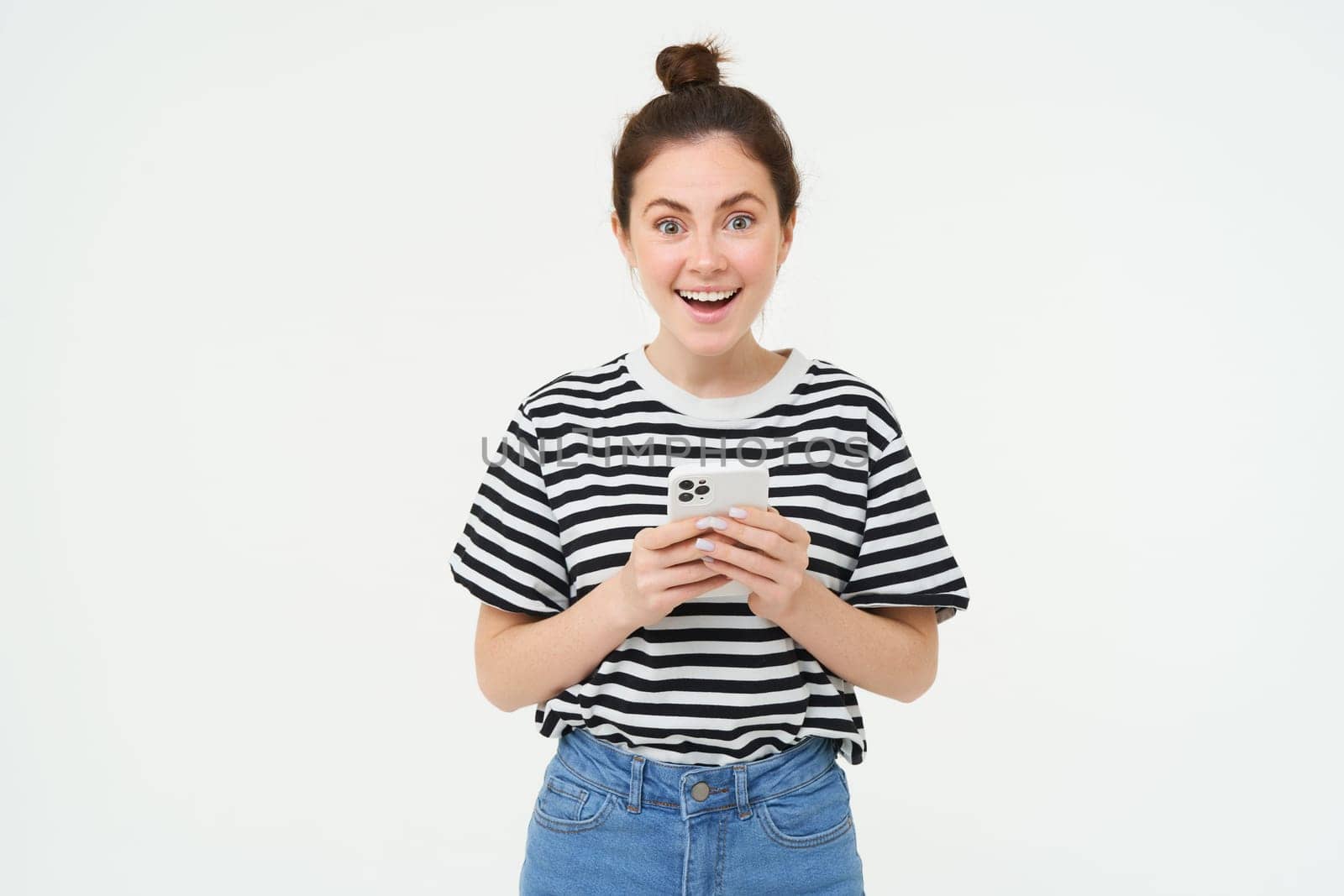 Technology and people concept. Young woman with mobile phone, smiling, using smartphone app, social media application, isolated over white background.