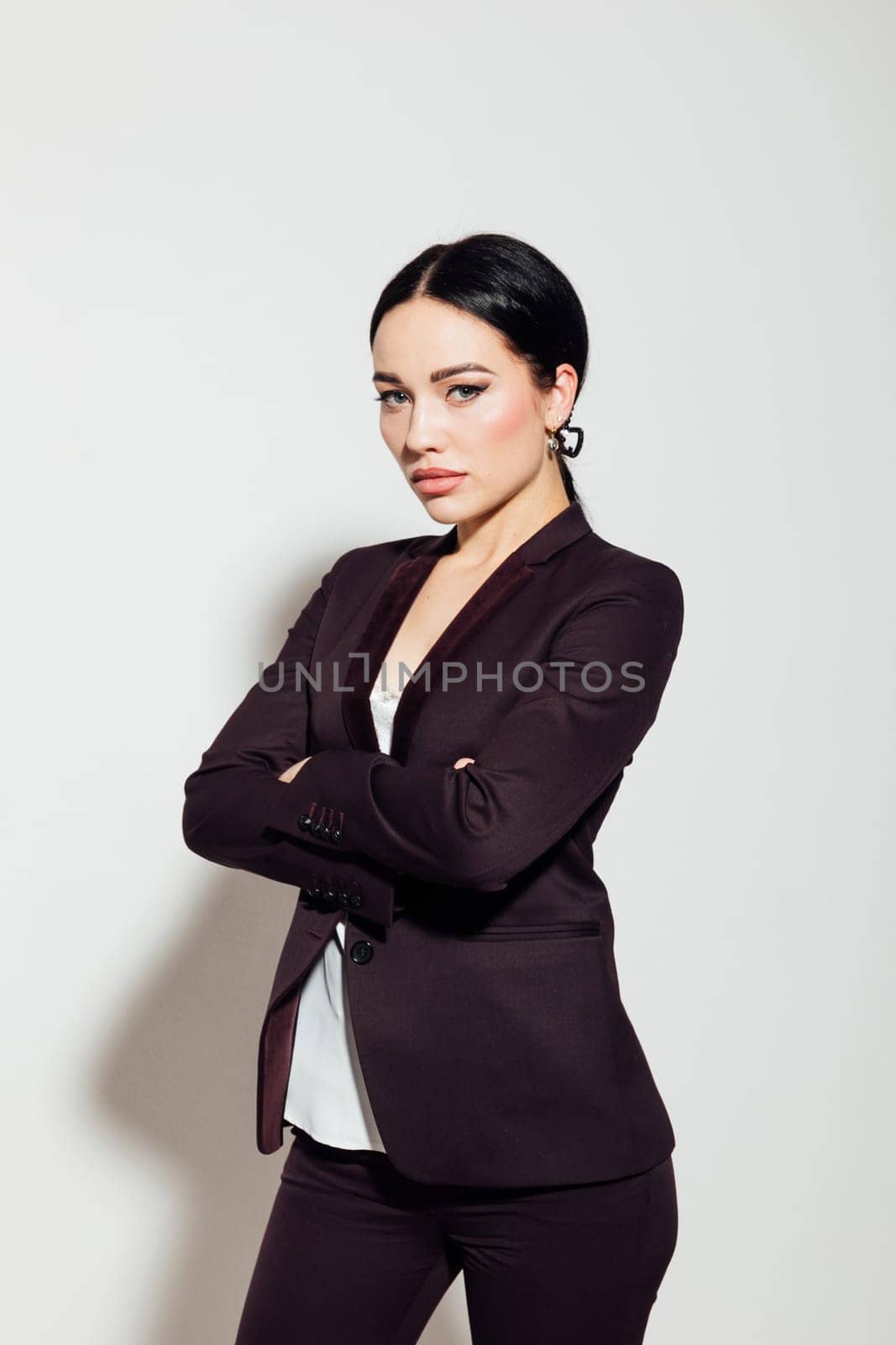 a business woman in a black suit stands on a white background by Simakov