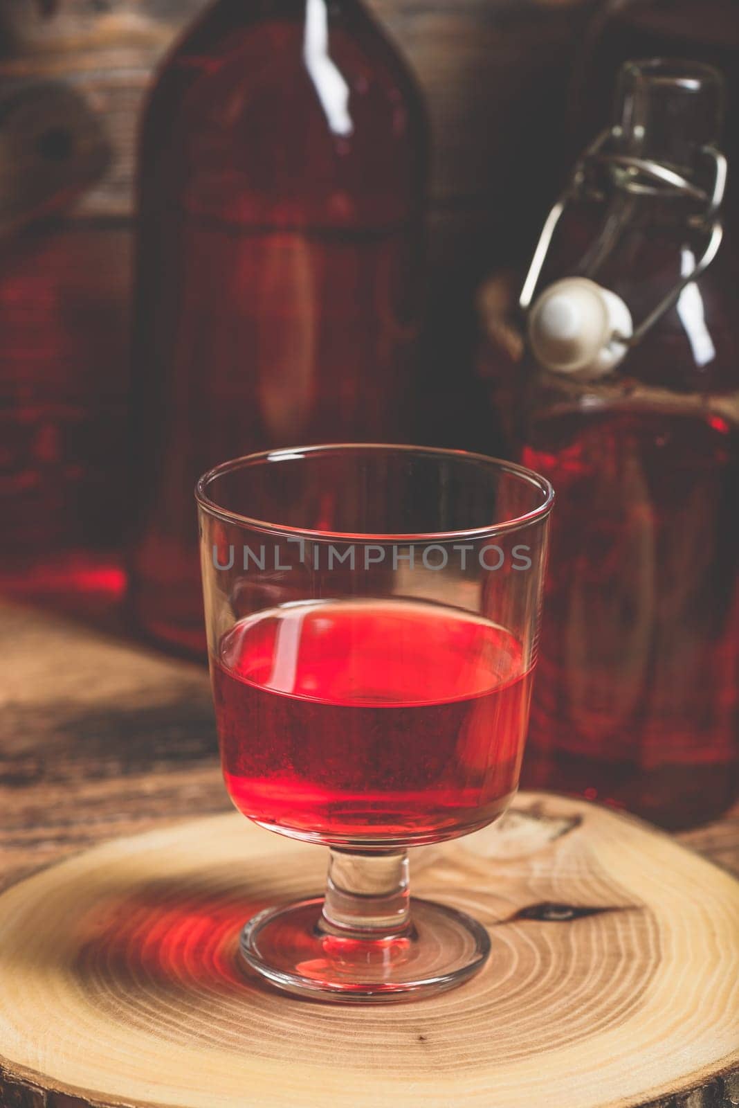 Homemade red currant wine in drinking glass