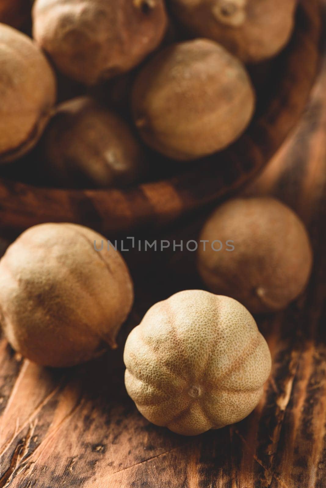 Sun dried limes in rustic wooden bowl
