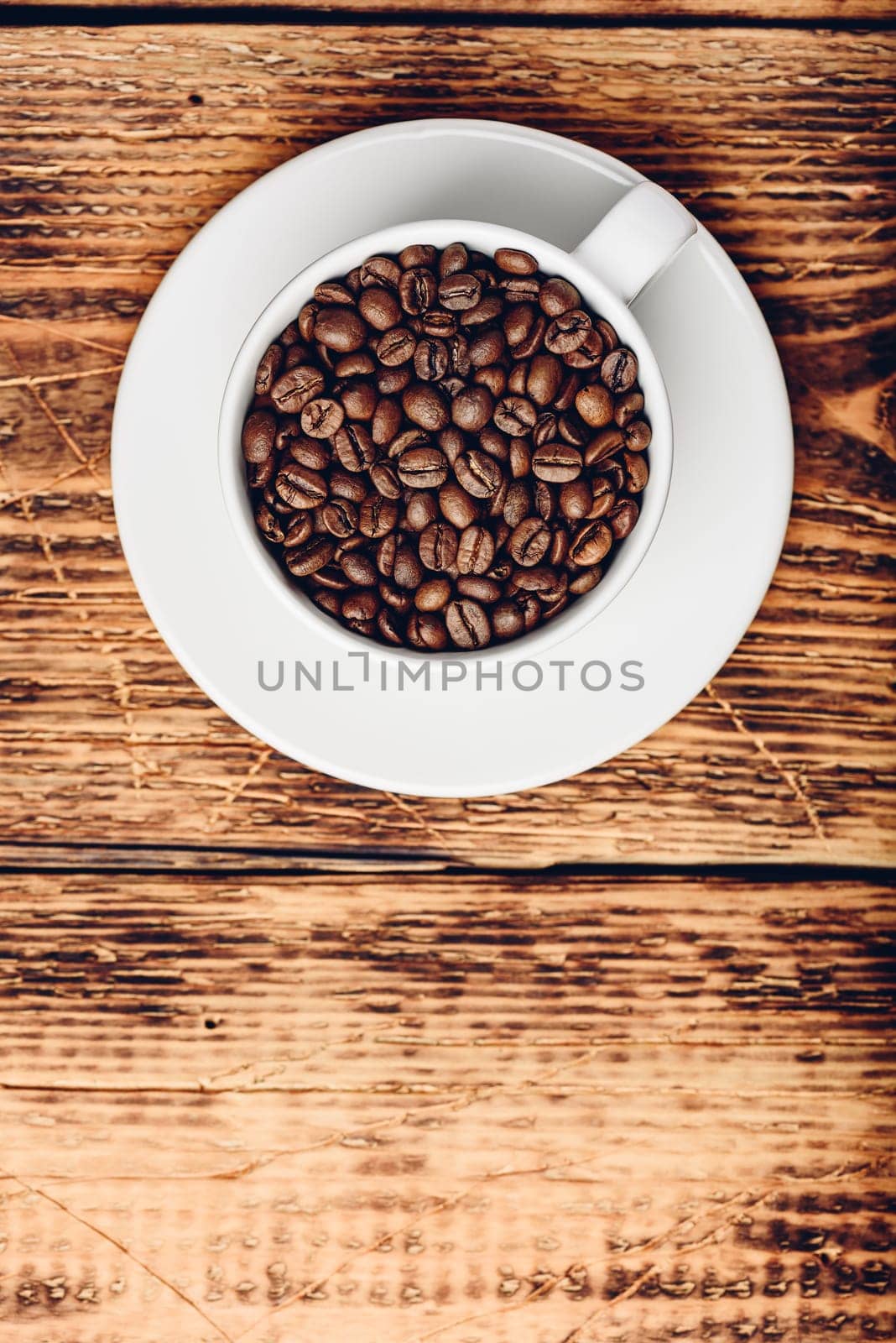Cup full of roasted coffee beans by Seva_blsv