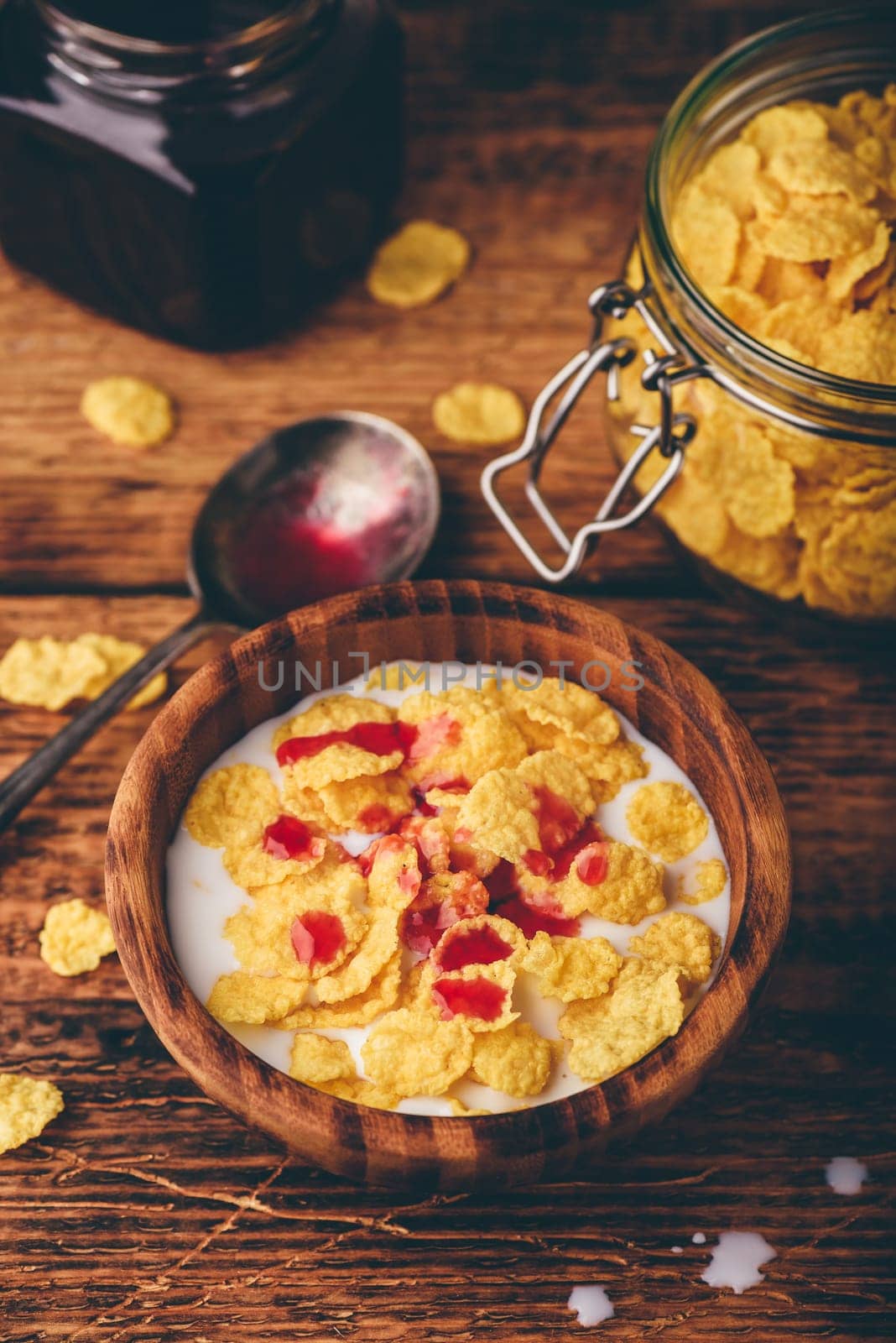 Breakfast with corn flakes, milk and berry syrup by Seva_blsv