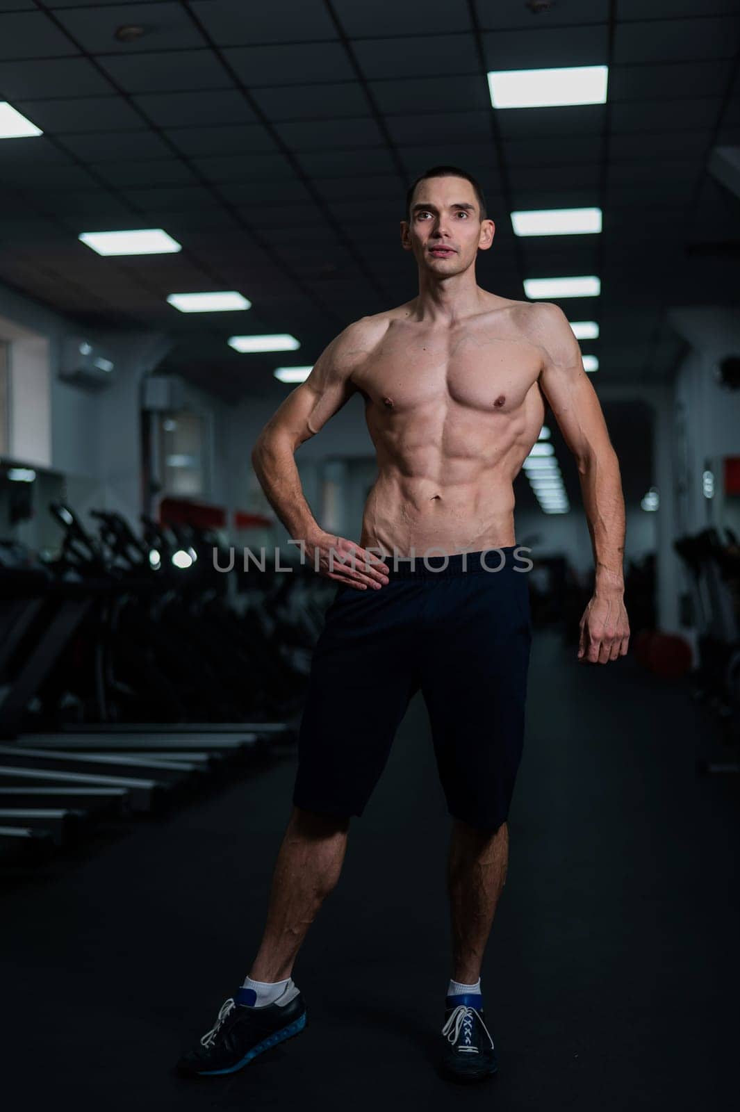 Shirtless man with sculpted body in the gym