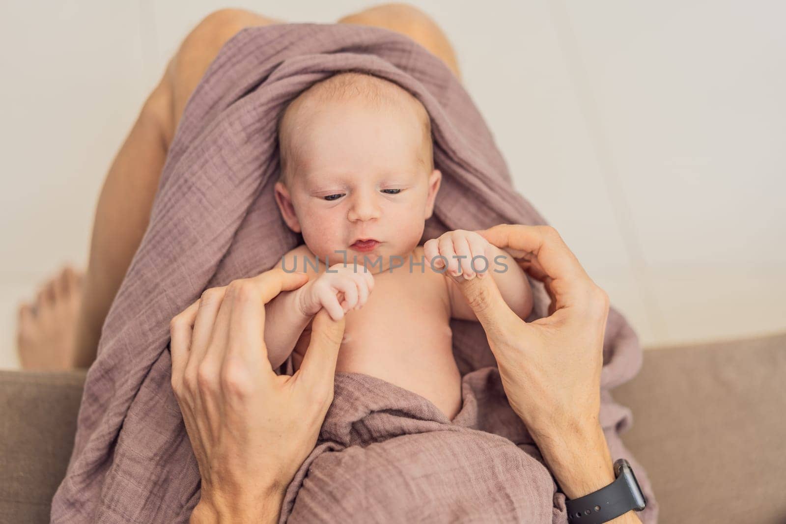 Dad and newborn at home. This tender moment captures the bond between father and child in a loving and comfortable family environment highlighting the joys of parenthood and the warmth of home.