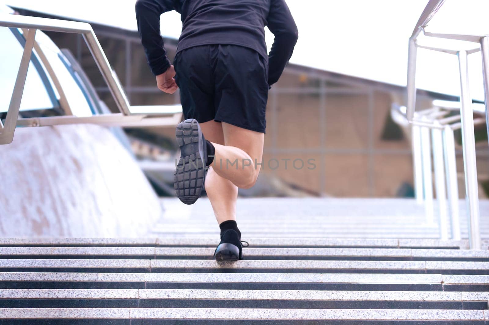 Man running down the stairs doing his daily cardio and warm-up exercise. Concept of Physical Activity