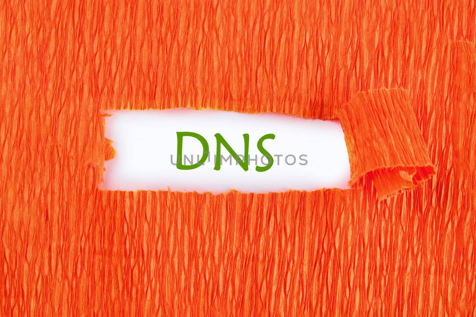 DNS (Domain Name System) acronym. DNS on white under the paper