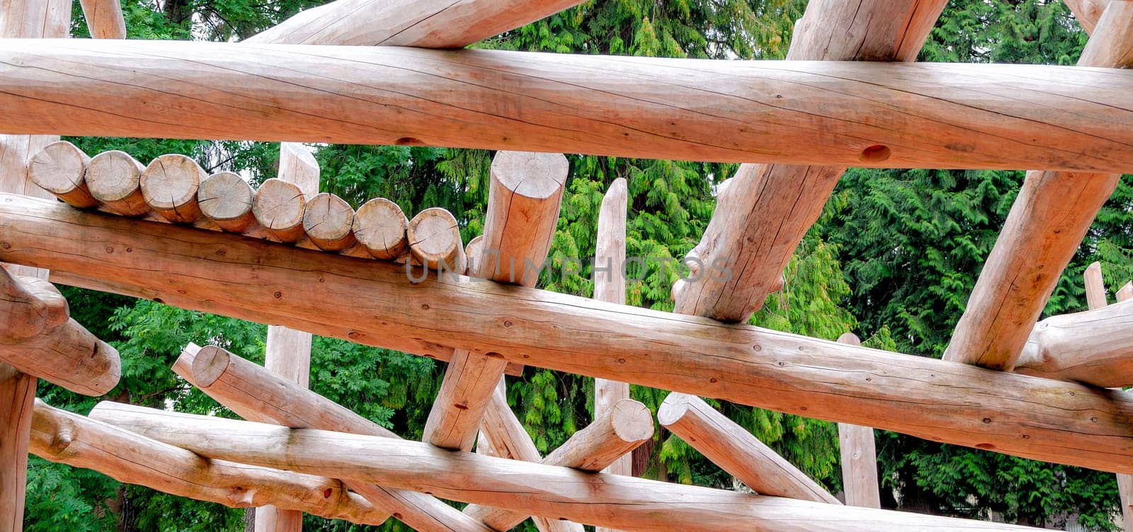 Adventure playground built with wood logs on green leaves backgfound.