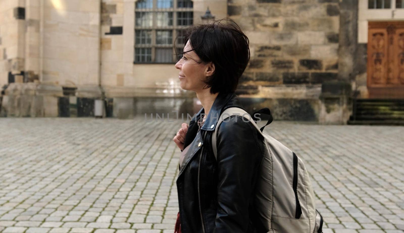 Girl Tourist, With Backpack, Explores Historical Part Of European City, Admiring Landmarks