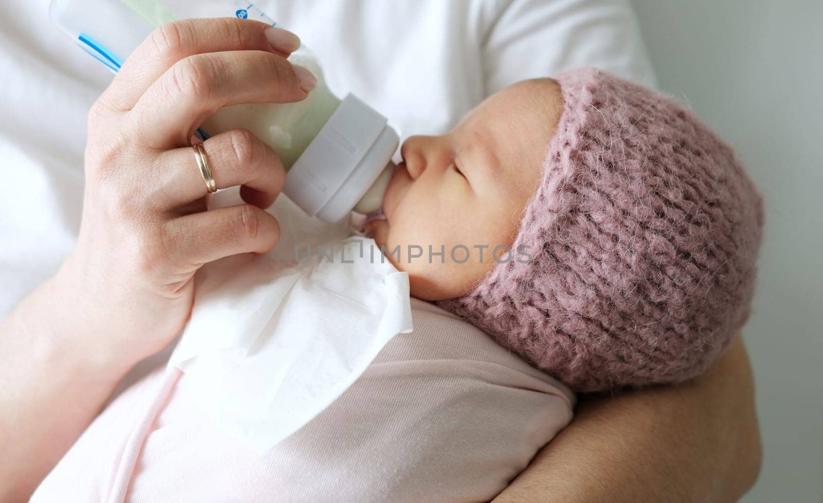 Mom Giving Her Newborn Baby Milk Formula From A Bottle