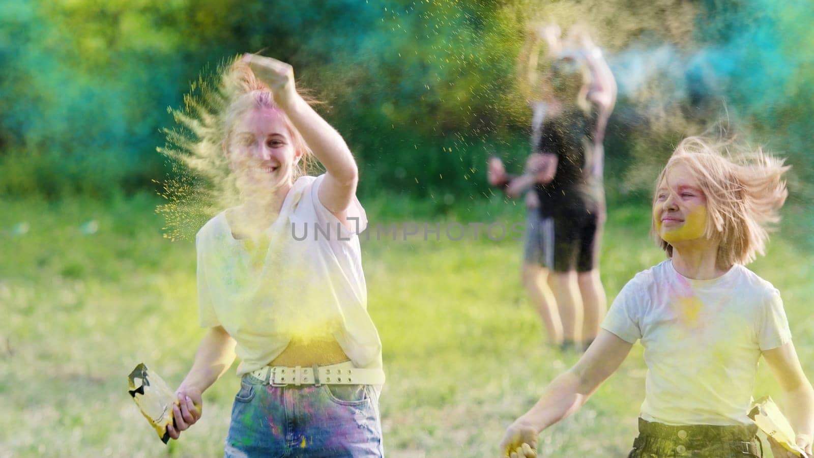 Sisters Tossing Dry Bright Paint On Holi Festival