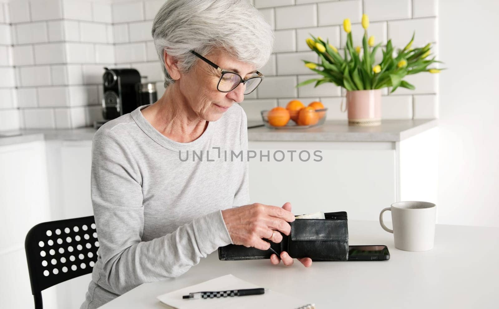Middle-Aged Woman's Hands Counting Euro Cash Notes In Her Wallet