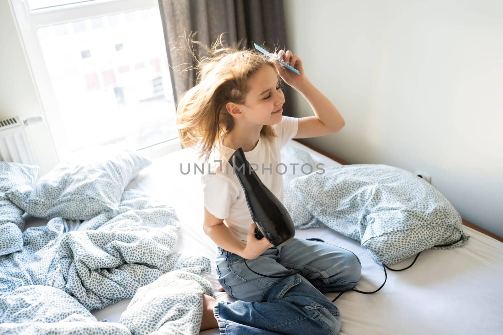 Cute Little Girl Drying Hair With A Hairdryer In Sleeping Room