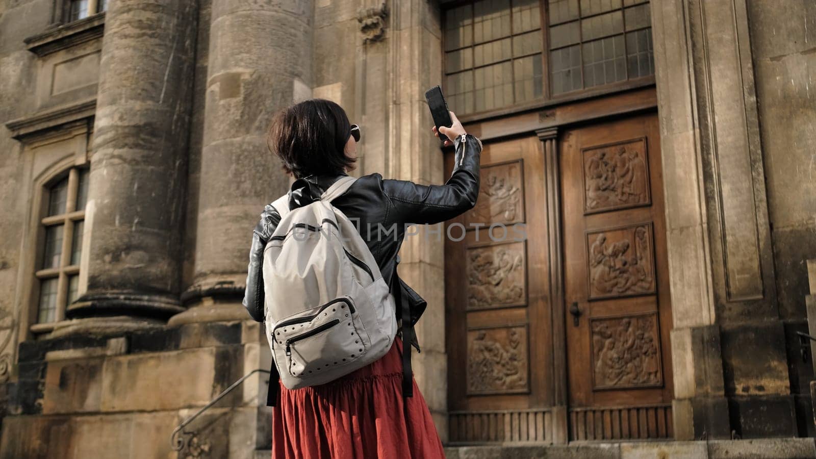 Attractive Female Tourist Walks With Germany Flag In Dresden'S Historical Center, Taking Pictures Of Sightseeing Spots