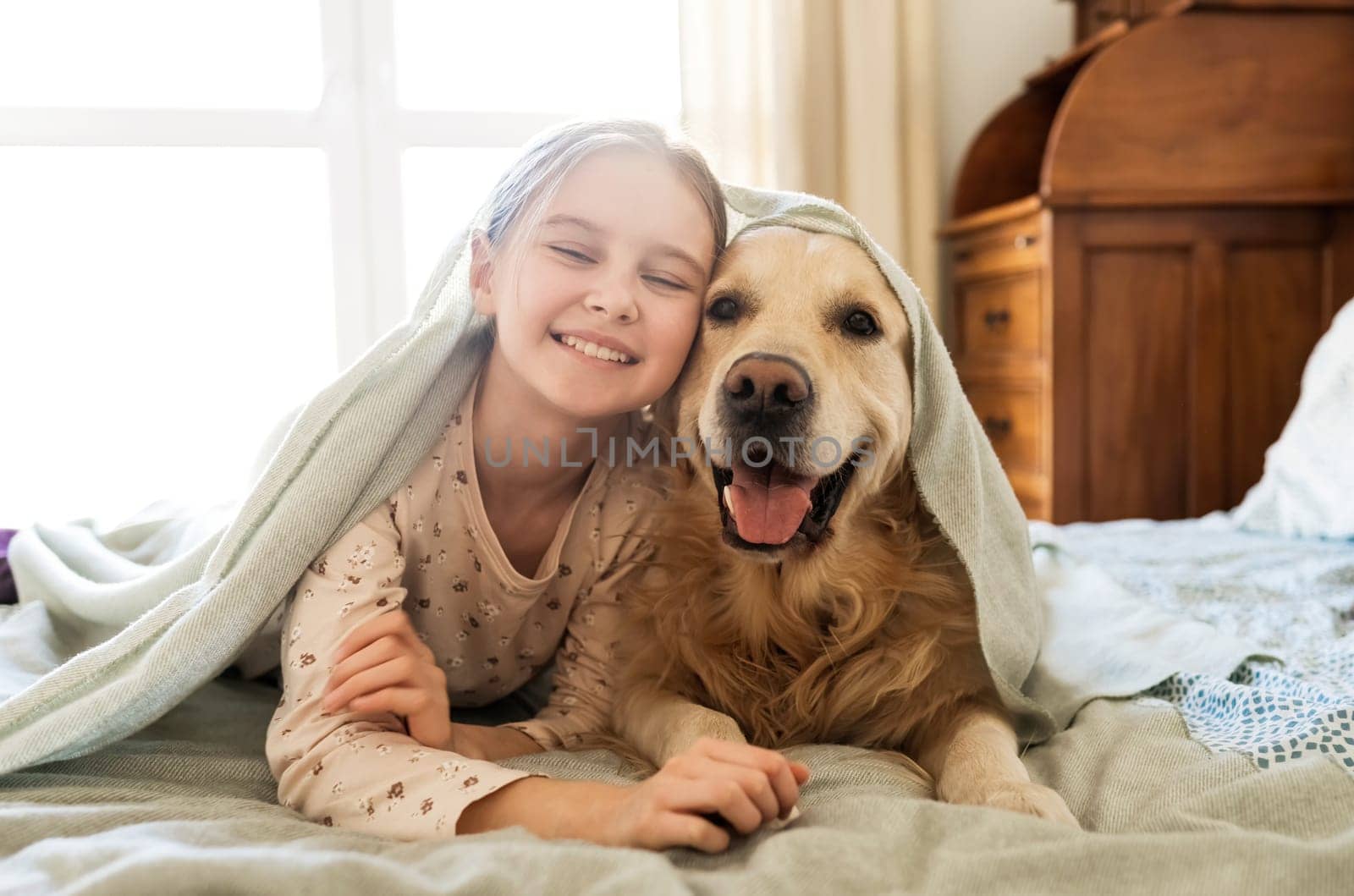Smiling Little Girl Playing With Golden Retriever Dog And Stick Out The Tongues