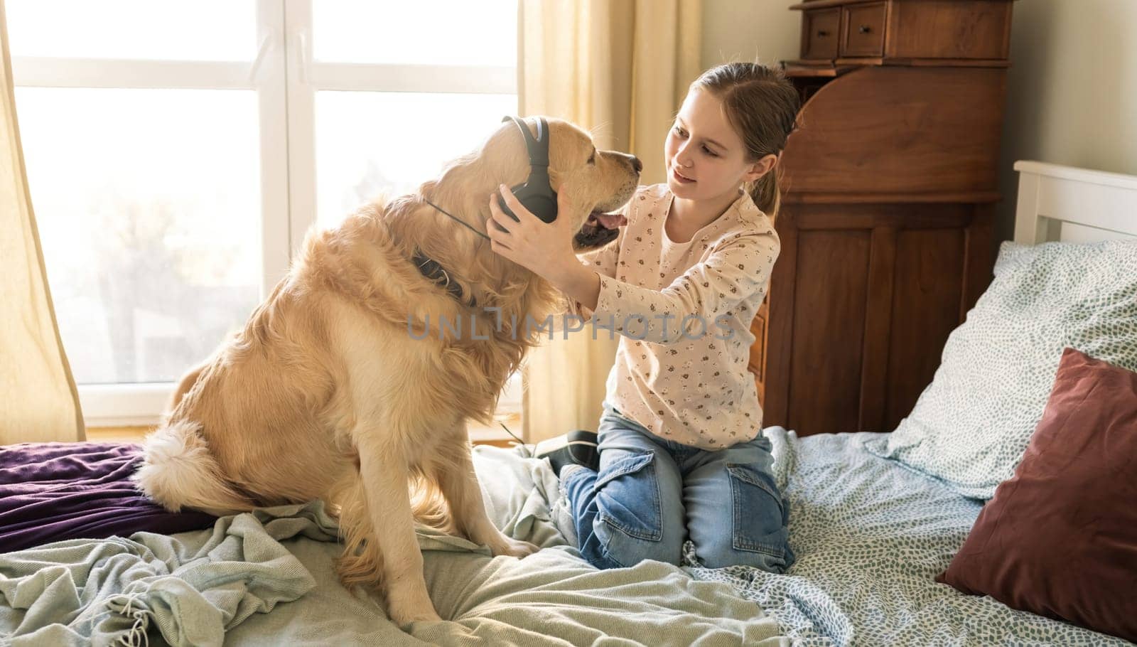 Joyful Little Girl Playing With Golden Retriever Dog And Wearing Headphones