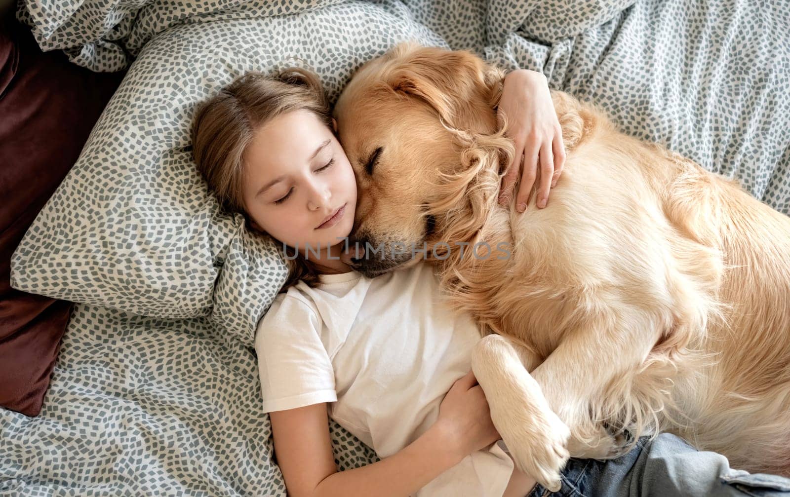 Cute Little Girl Sleeping With Dog In Embrace In Bed