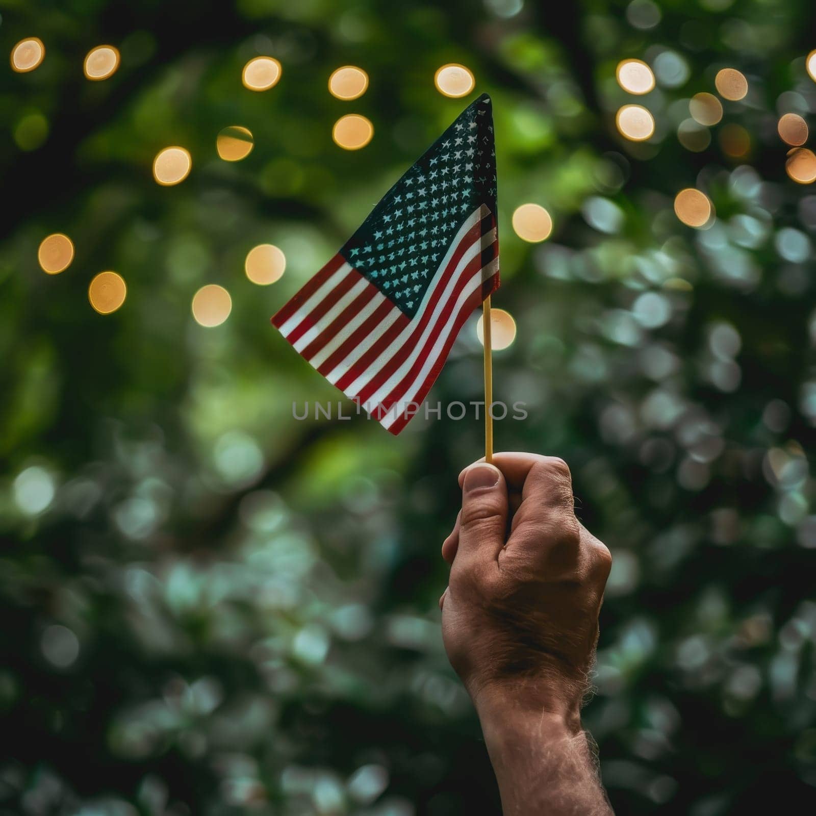 Focused image of a hand proudly holding a flag, of America is Independence Day