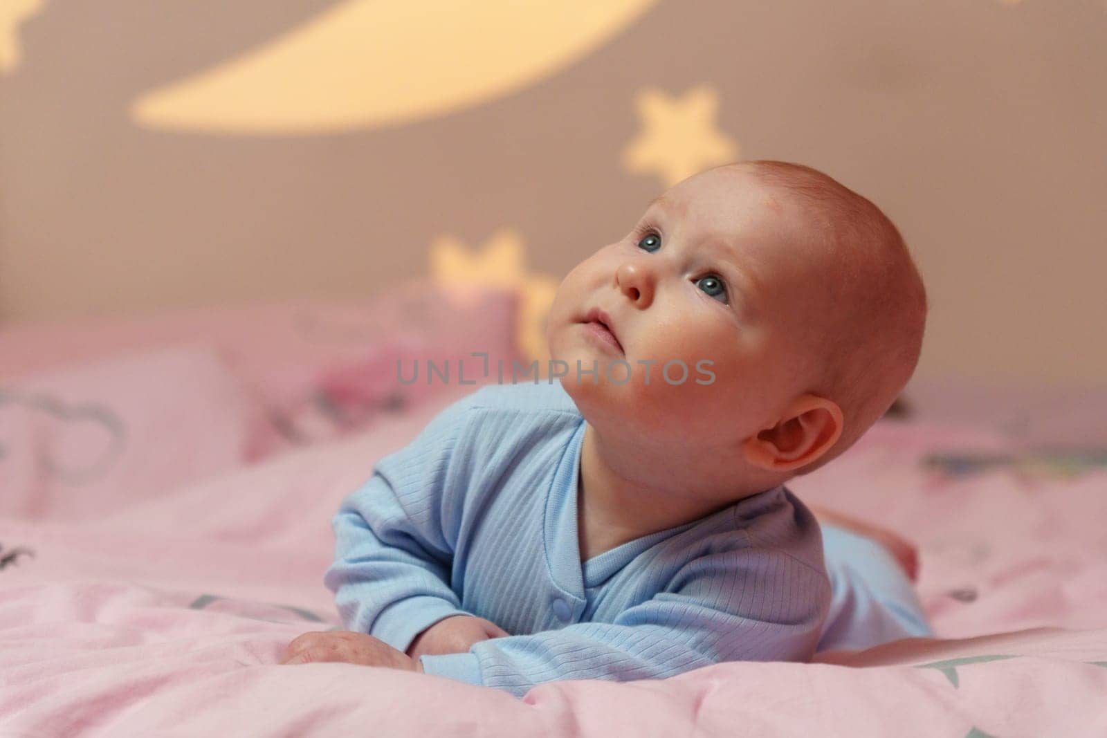 Dream Baby Nestled Among Moon and Stars in Bed, going to sleep.