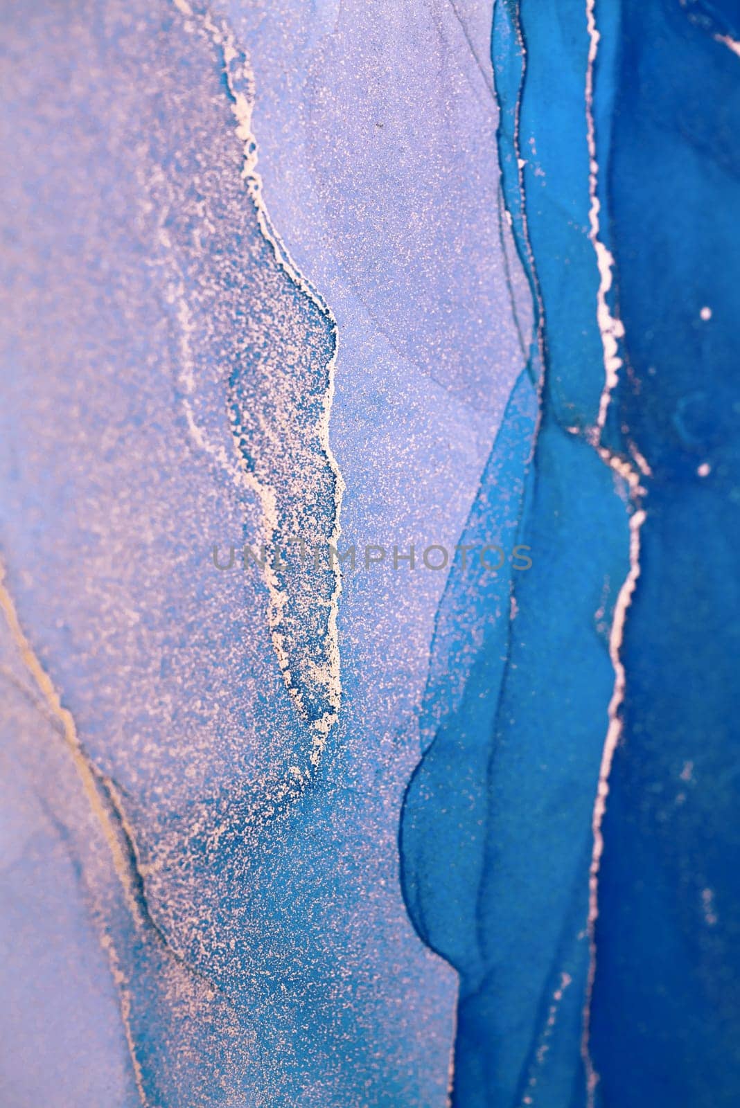An abstract painting featuring flowing, swirling teal and silver ink. The artwork creates a sense of depth and movement, with light and dark areas intermingling.