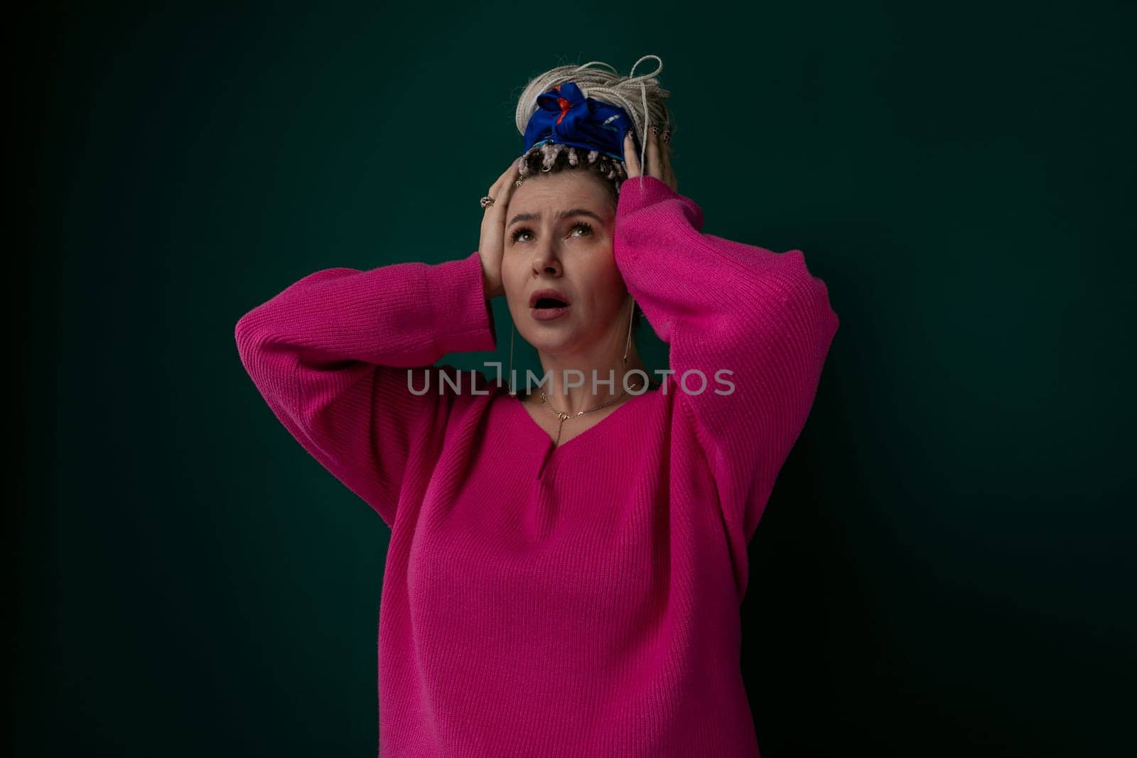 A woman is pictured wearing a crown on her head. She appears confident and regal, with a hint of elegance in her posture and expression. The crown is ornate and shines under the light.