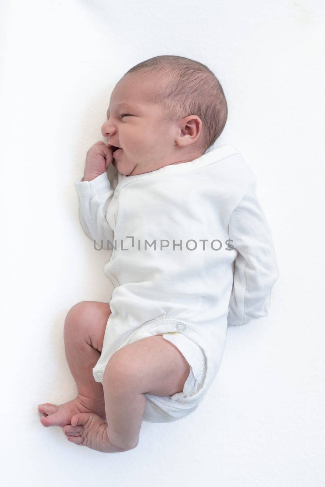 Newborn baby on white blanket. High quality photo