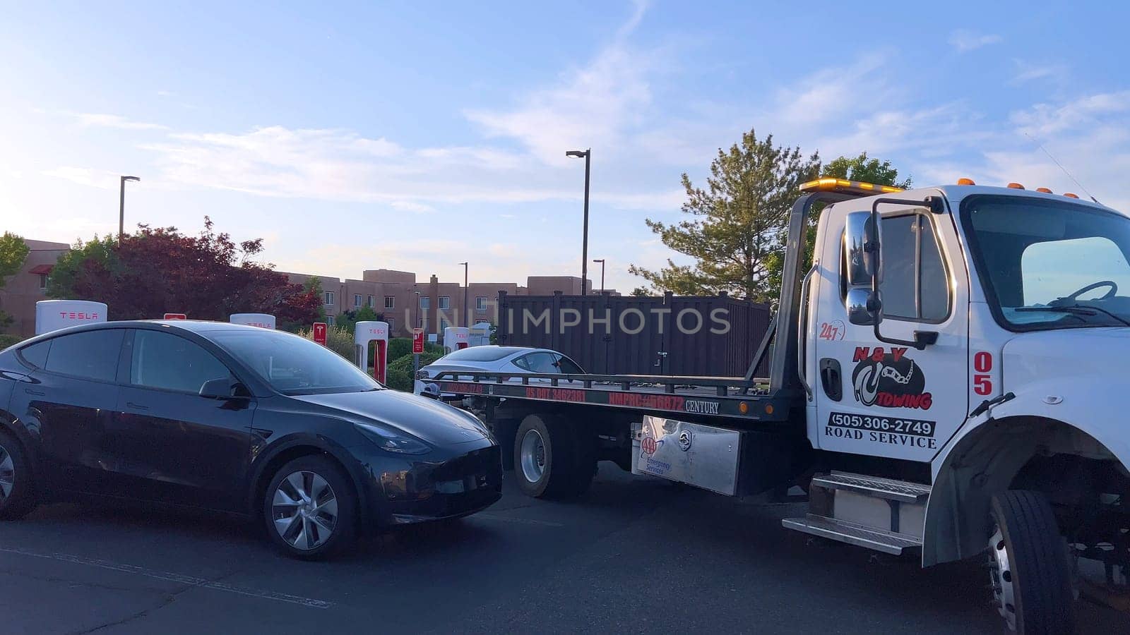 Tesla Being Delivered to Charging Station After Running Out of Charge by arinahabich