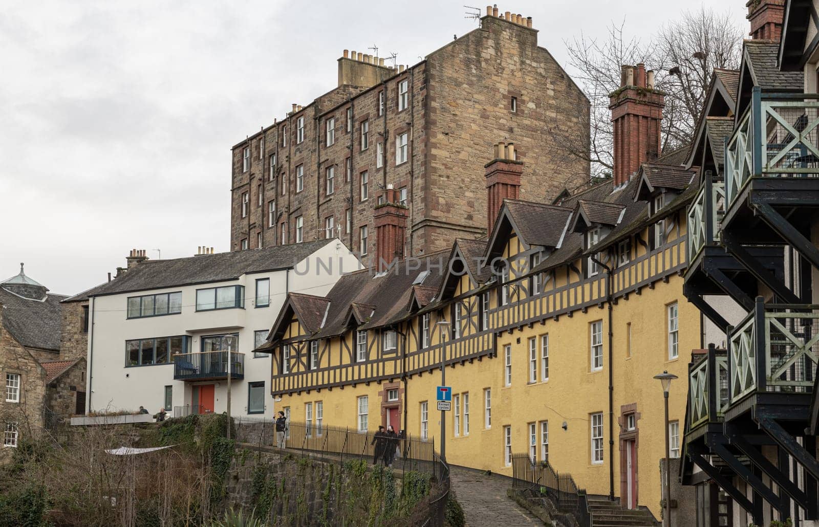 Edinburgh, Scotland - Jan 16, 2024 - Hawthorn Buildings is a traditional old Tenement building on Hawthornbank Lane in Dean Village with river and stream which sits along the banks of the Water of Leith. Copy space, Selective focus.