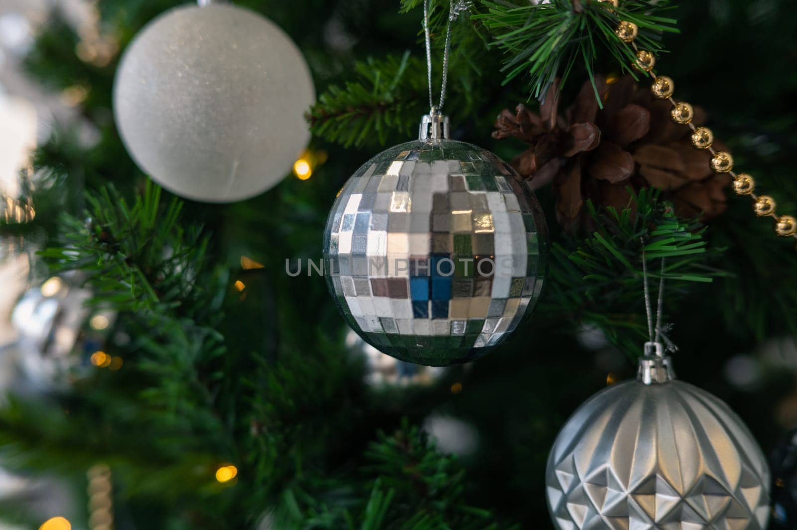 Christmas tree branch decorated with beauty balls and other christmas tree decoration
