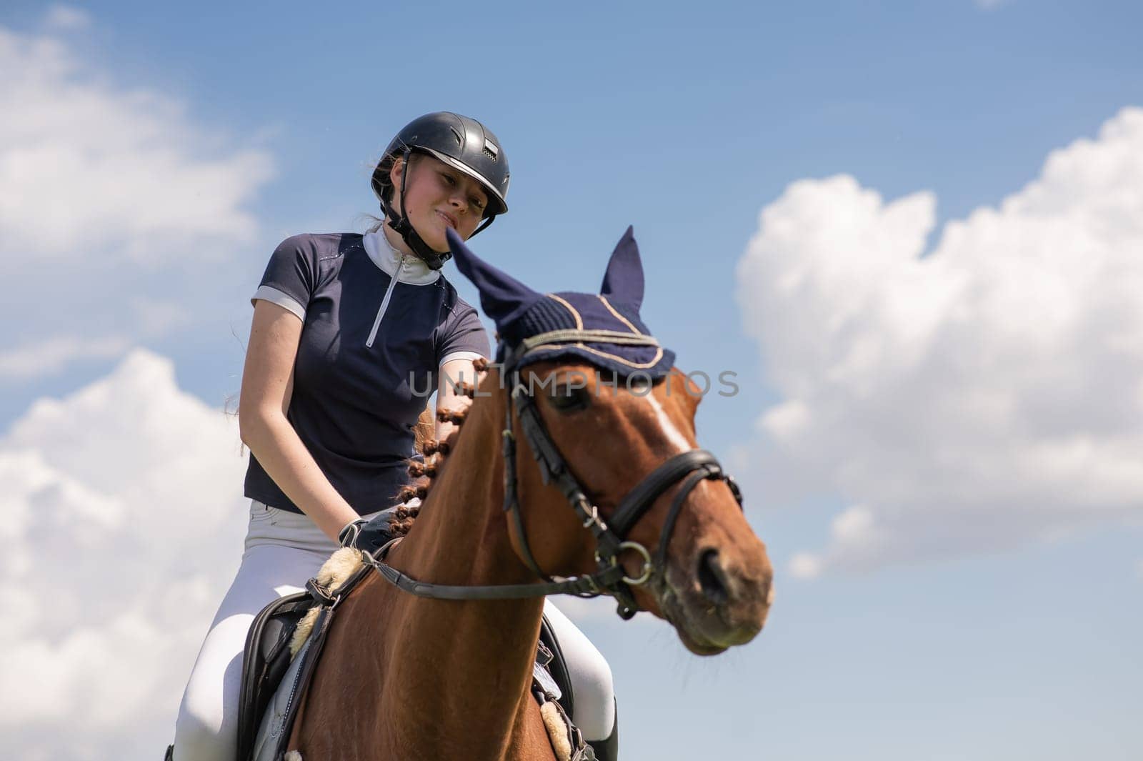 Portrait of a girl jockey riding a horse