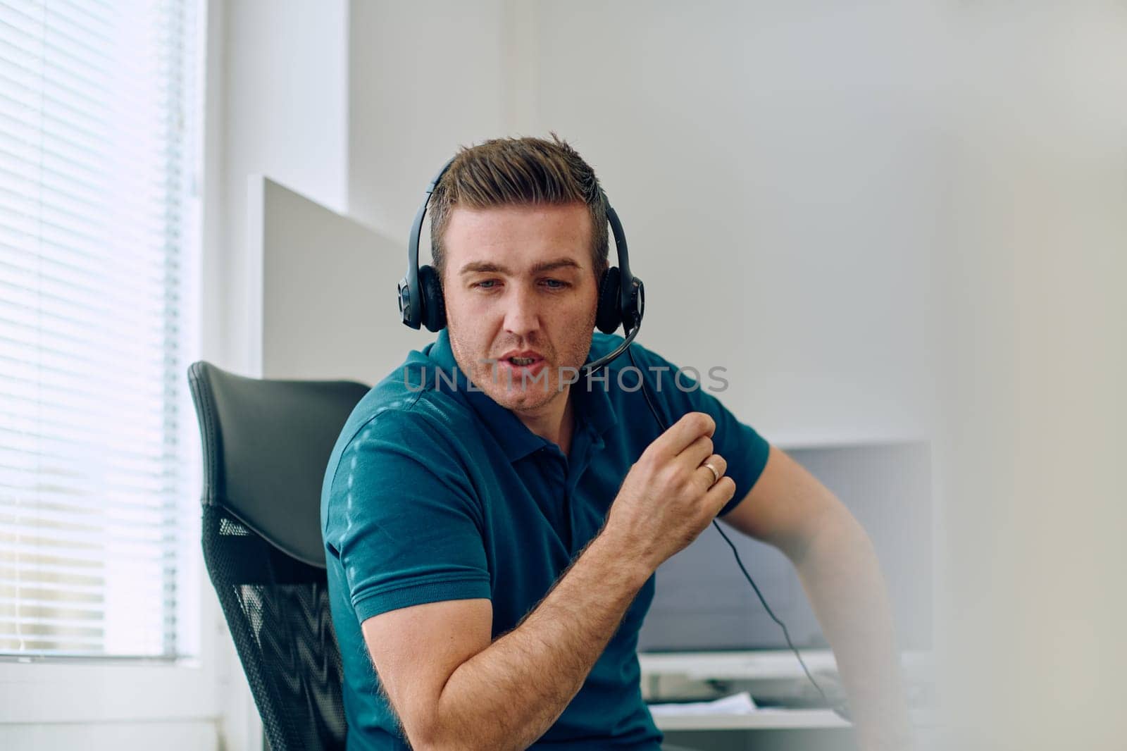 A detailed close-up captures a focused customer support representative wearing a headset while providing assistance in a call center setting.