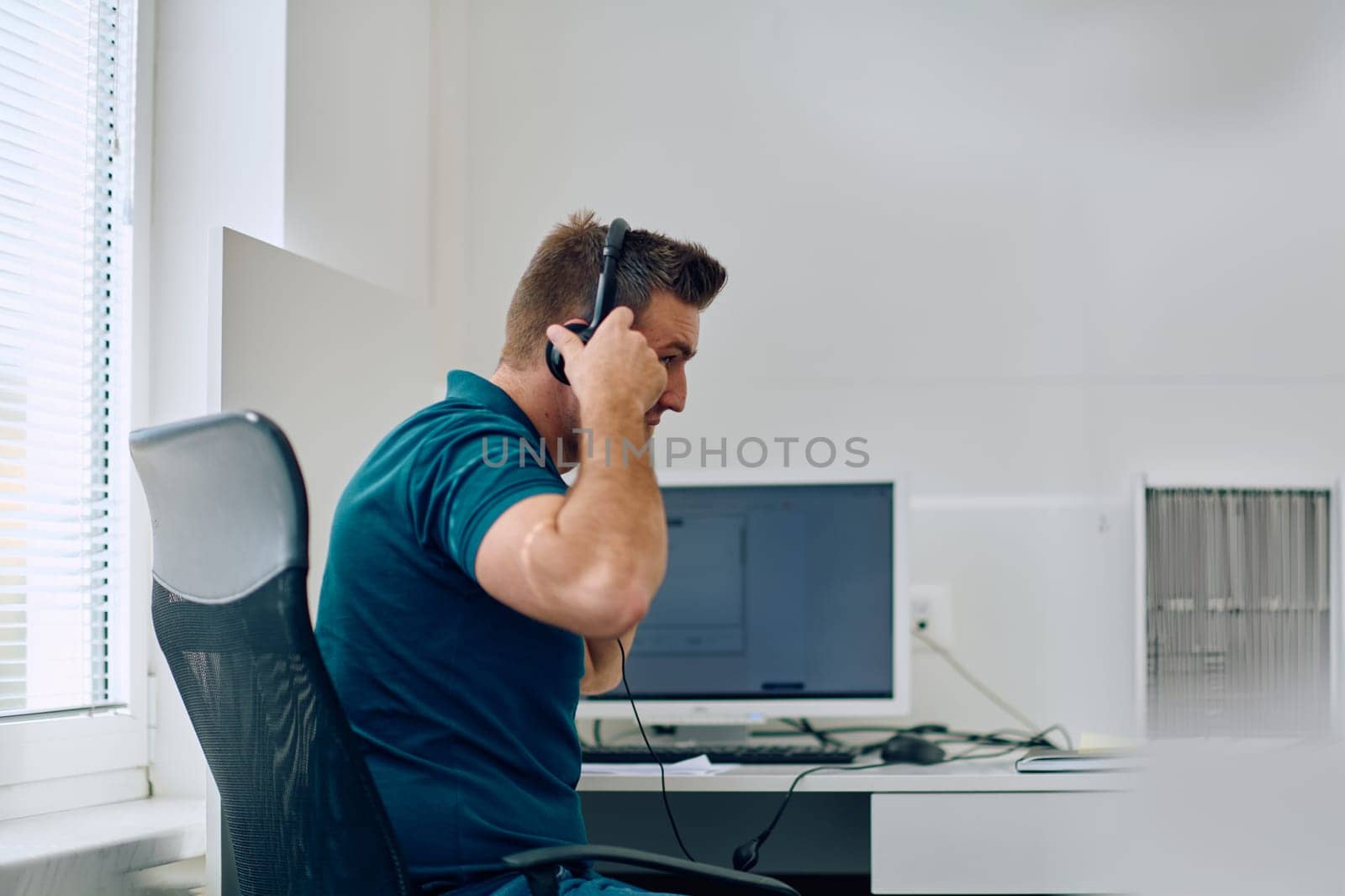 A detailed close-up captures a focused customer support representative wearing a headset while providing assistance in a call center setting.