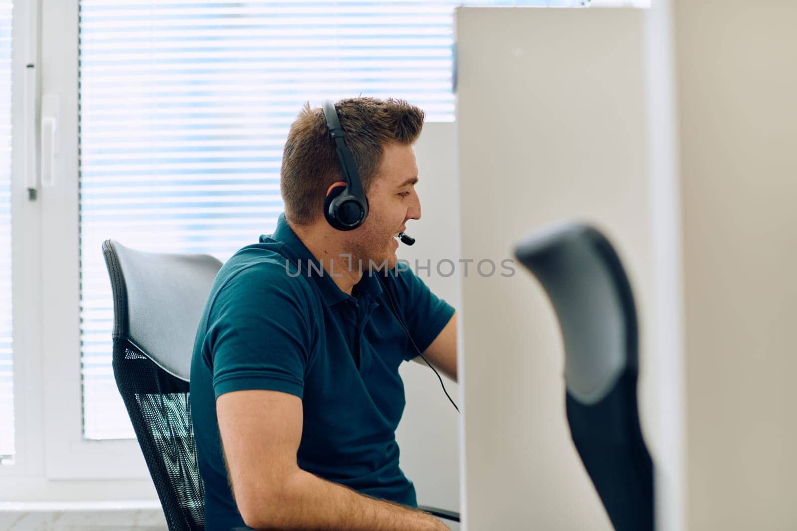 A detailed close-up captures a focused customer support representative wearing a headset while providing assistance in a call center setting.