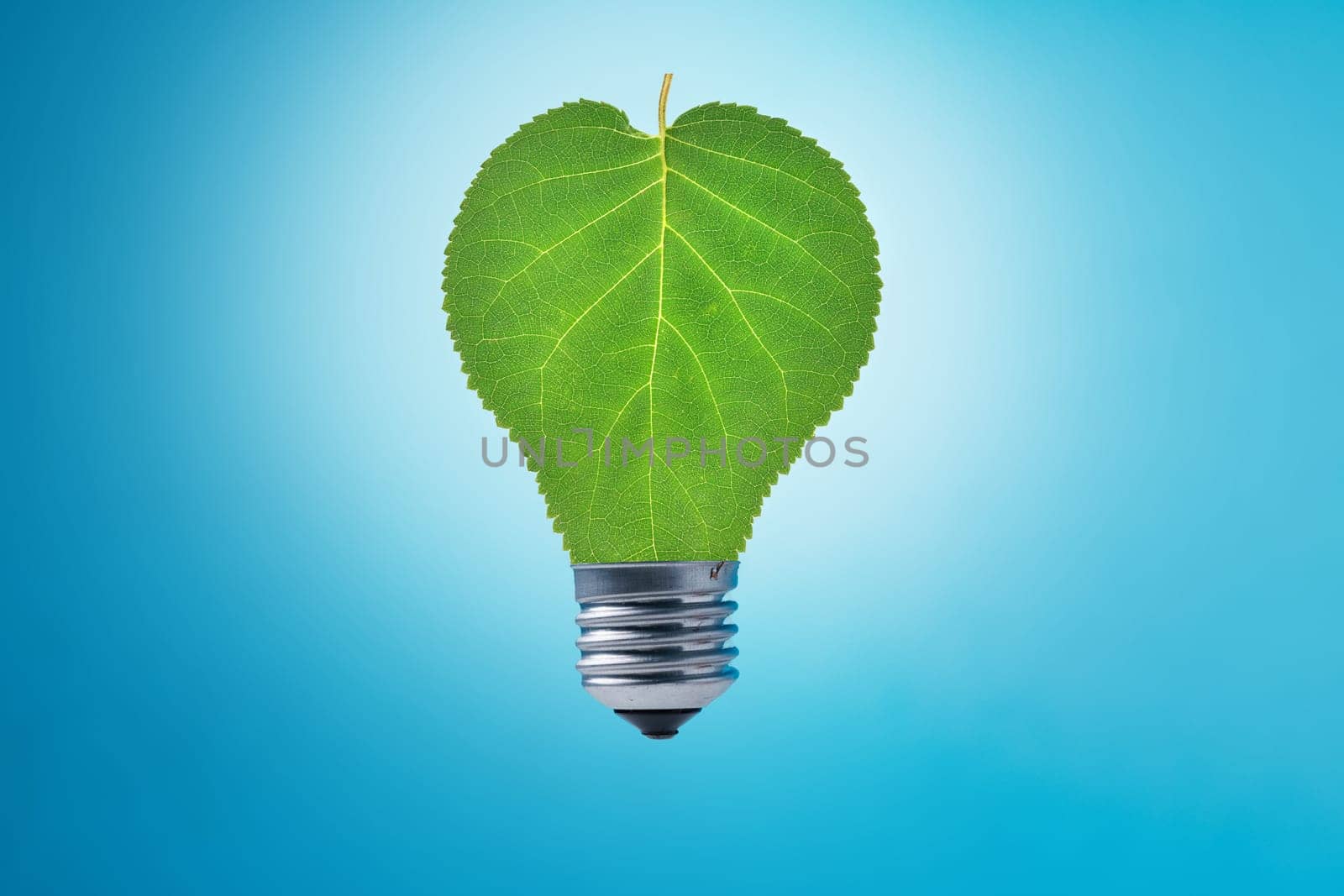 Light bulb with green leaves on blue background. Sustainable energy, Save the Planet, Earth hour concept