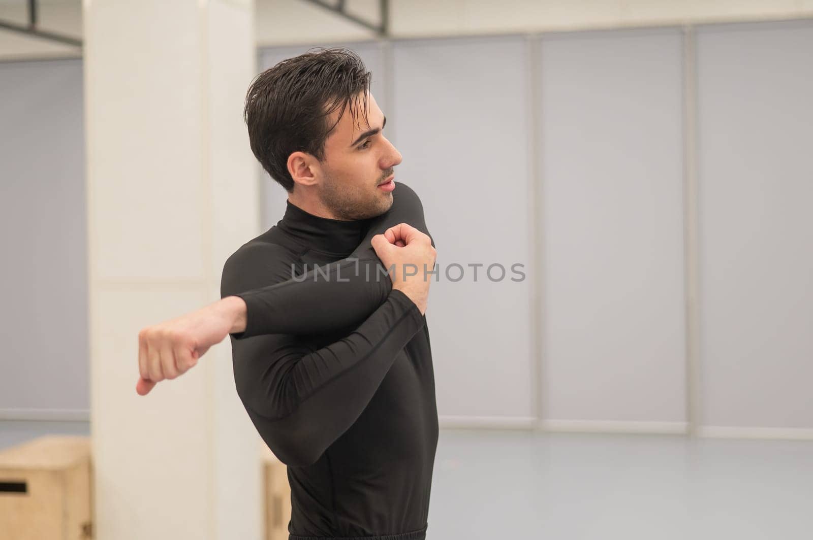 Caucasian man doing warm-up before exercise at a climbing wall. by mrwed54