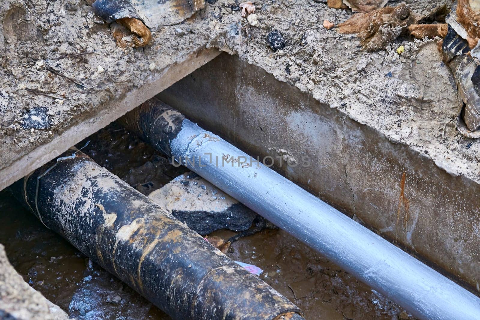 Excavated pit with plastic plumbing sewage pipes for repair and installation by jovani68