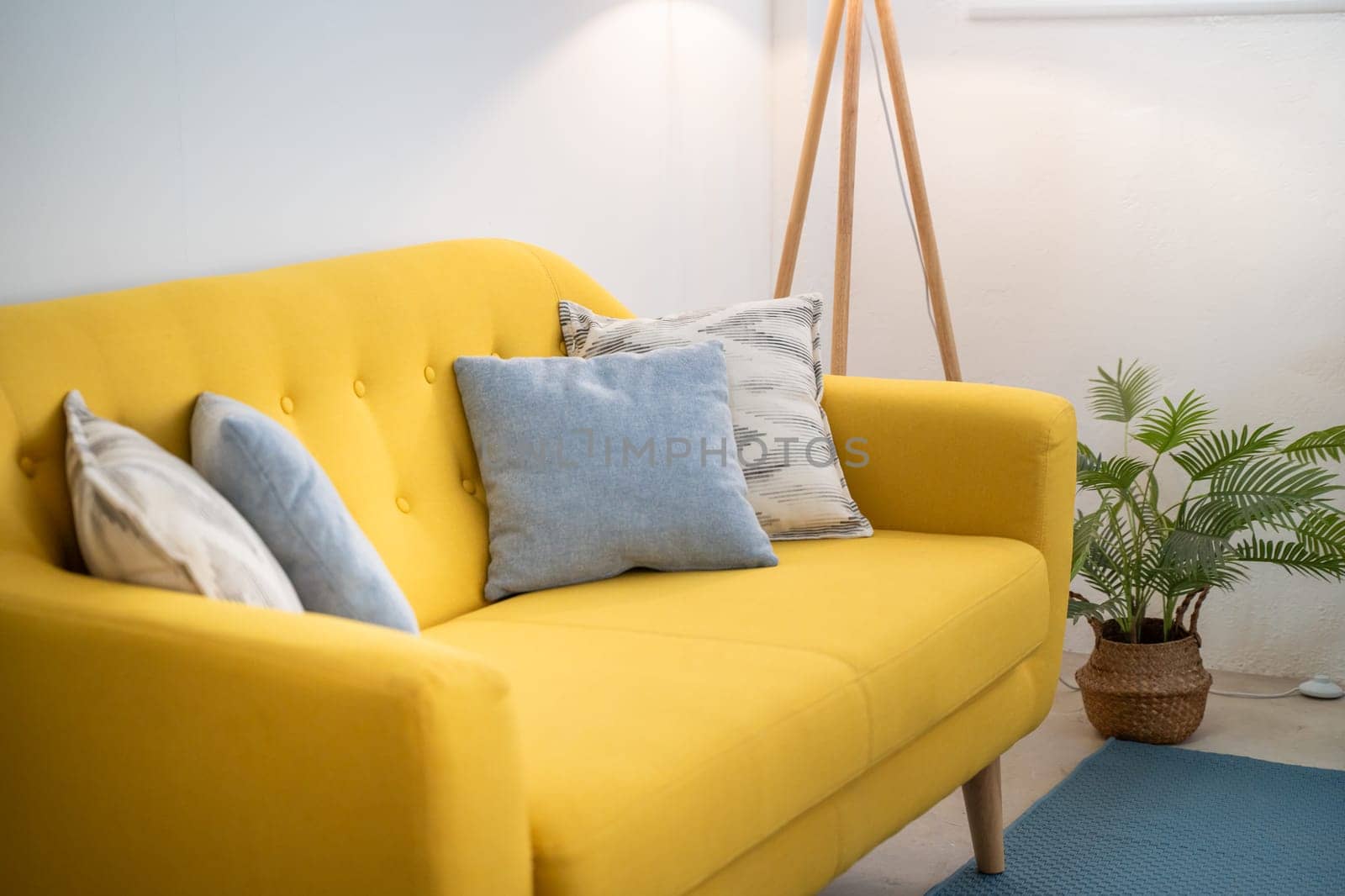 Interior design featuring a yellow couch in a living room industrial loft. High quality photo