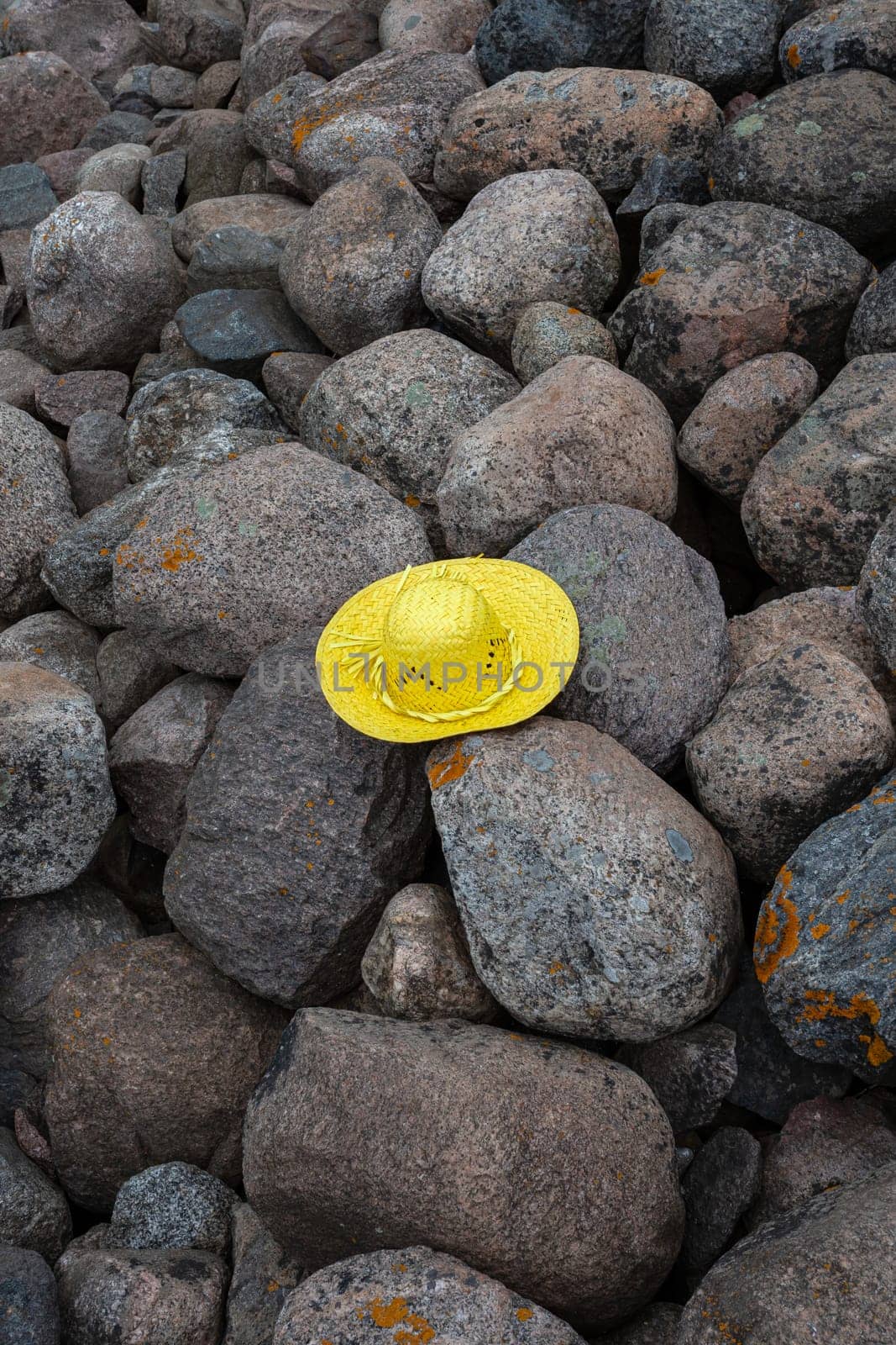 Huge boulders scattered randomly on the site of an old stone pier. Stones background and texture. Ainazi North Pier