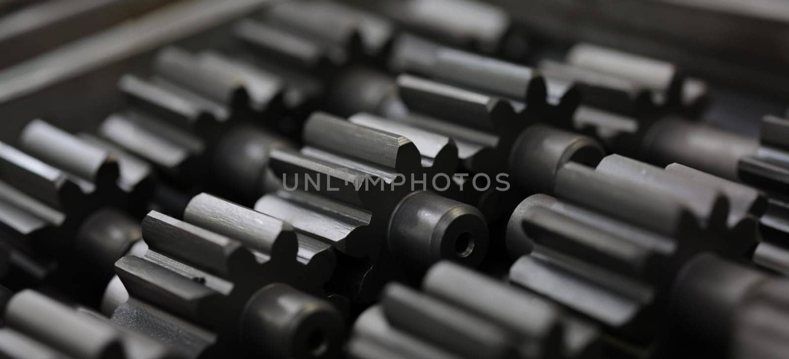 Lot of black metal parts lying on table closeup. Sale of auto parts concept