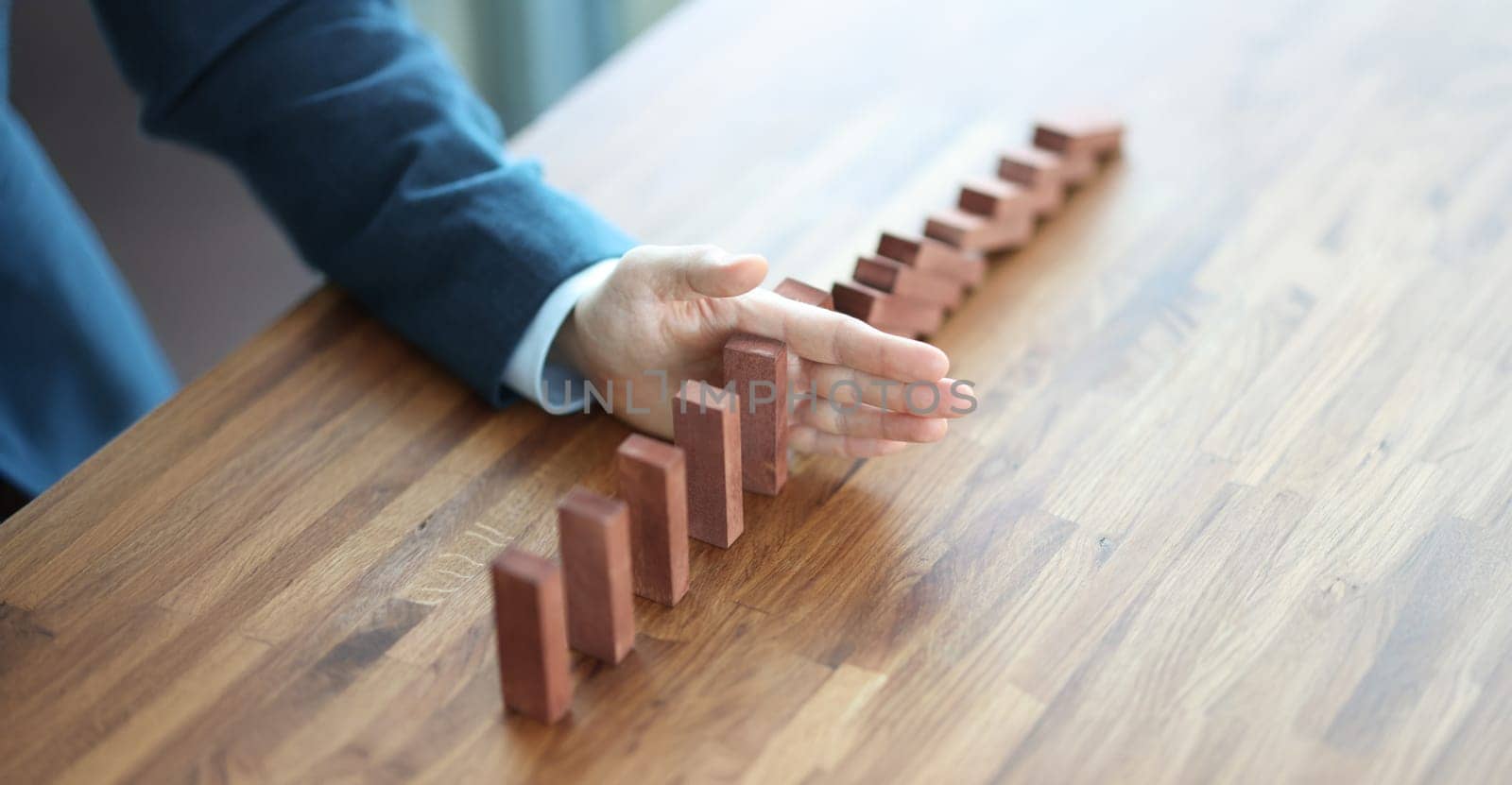 Businessman hand separates wooden blocks on table. Making important management business decisions concept
