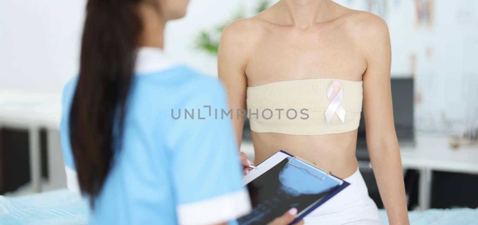 Doctor examines female mammary glands of patient by kuprevich