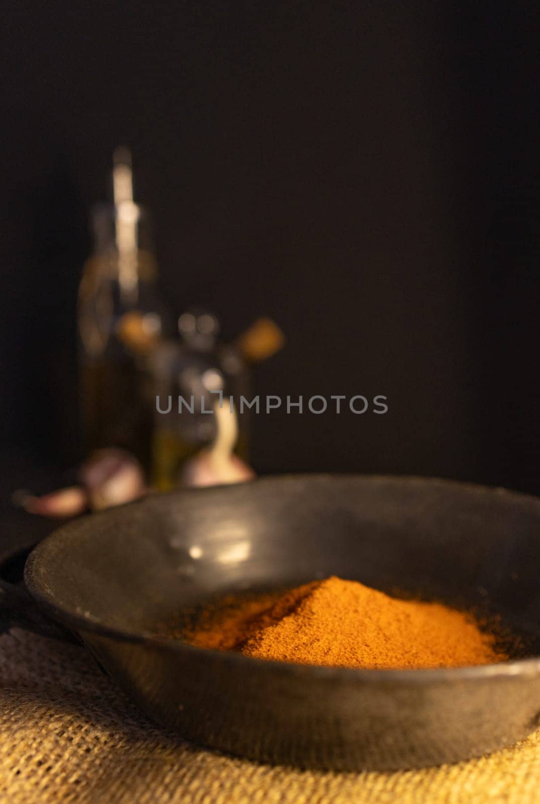 Red paprika on a rustic plate in a country kitchen. Dark background by VeroDibe