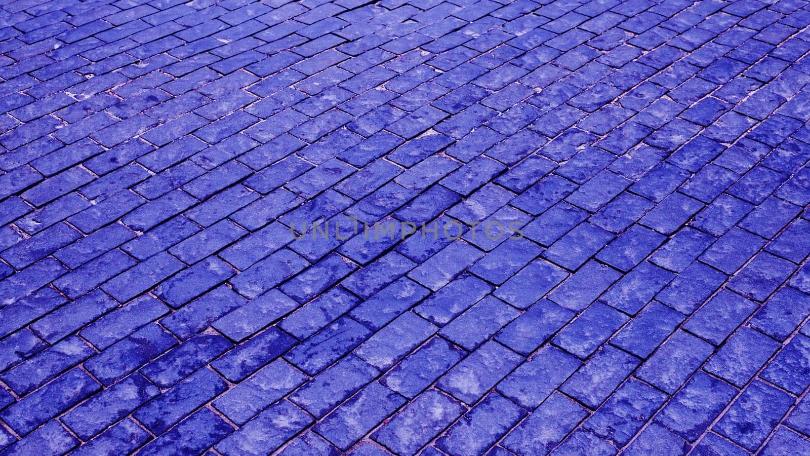 Fragment of an old square with blue paving stones. .Old, vintage, decorative paving stones.