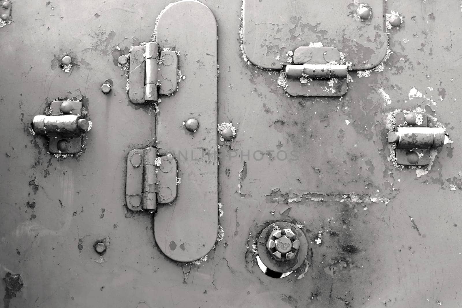 Close-up of a rusty metal surface with rivets and bolts