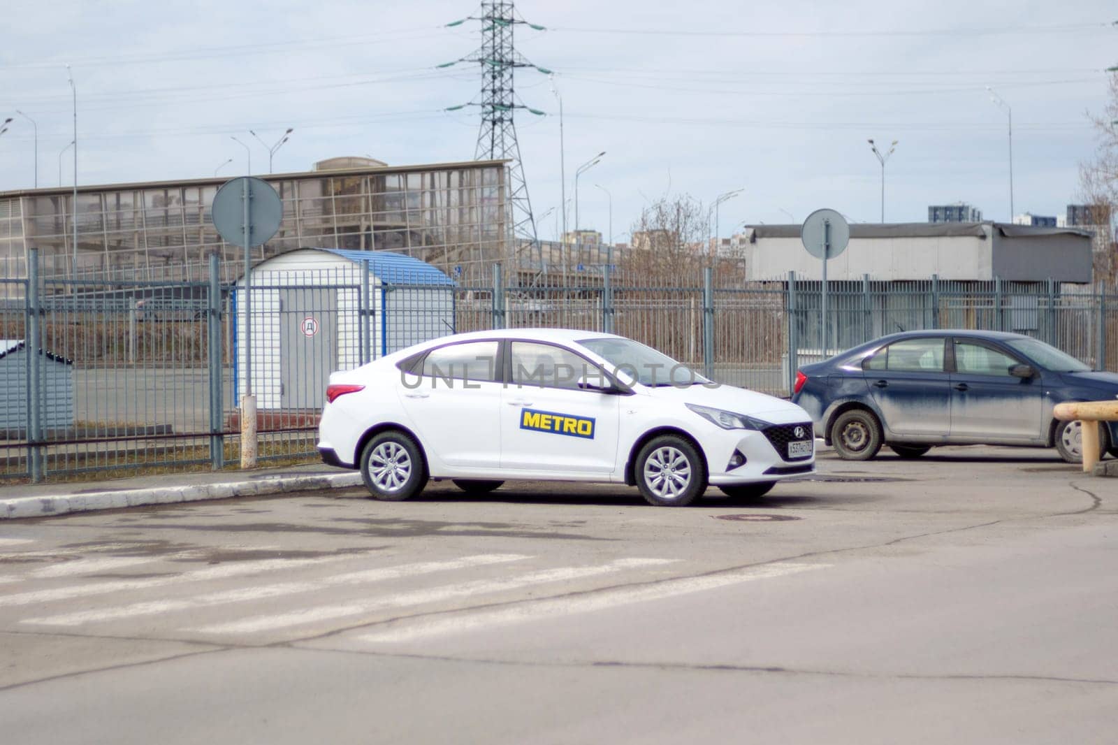 Tyumen, Russia-March 02, 2024: Metro logo on a white car. Metro cash and carry hypermarket