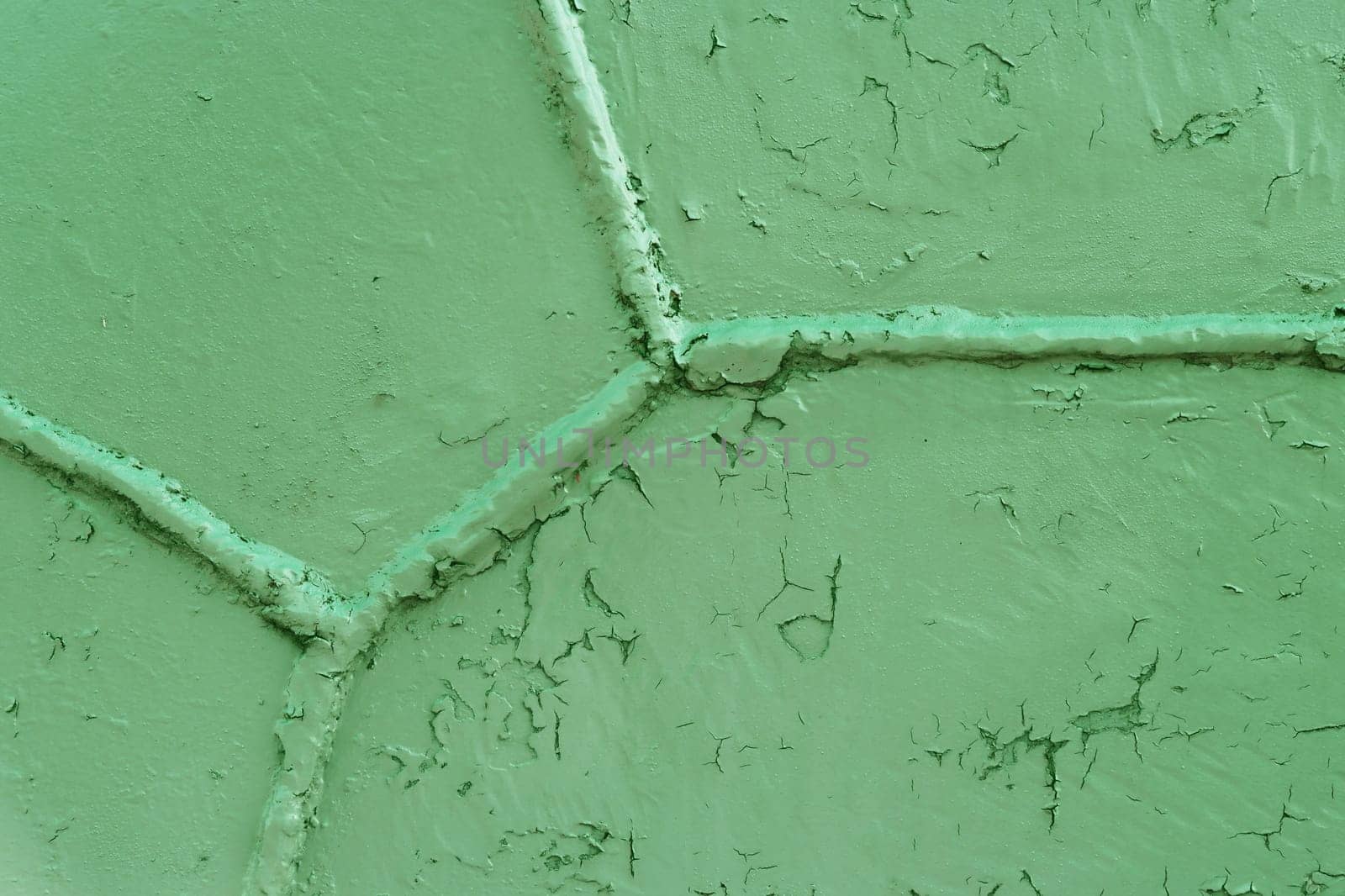 Green metal surface with a weld seam. Grunge metal texture. Green grunge metal textured wall background.