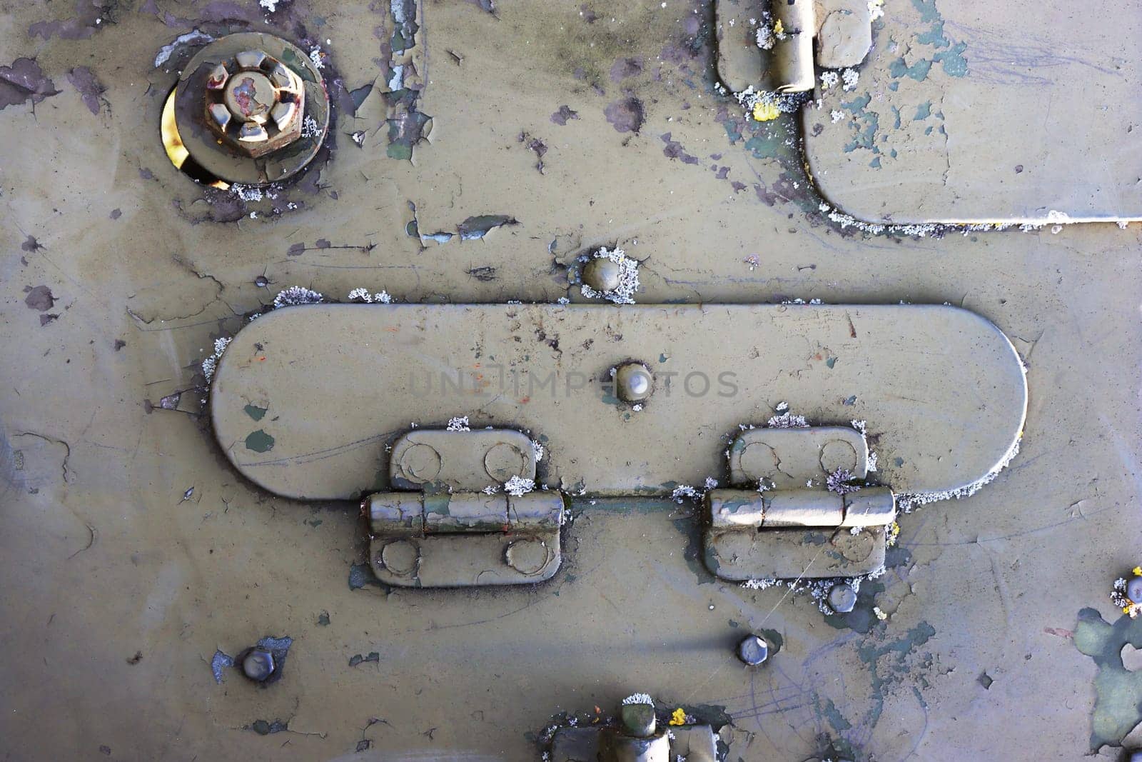 Detail of an old military armored vehicle with a door lock.